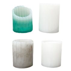 four different colored glass vases sitting next to each other