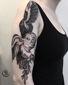 a woman with an owl tattoo on her arm