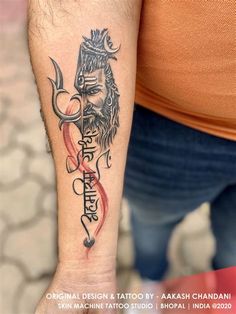 a man with a tattoo on his arm and the word buddha written in different languages