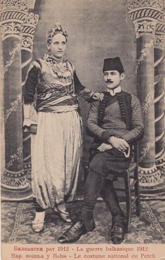 an old black and white photo of people dressed in historical clothing, standing next to each other