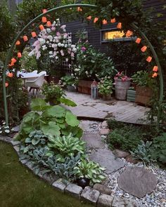 an outdoor garden with lots of plants and flowers