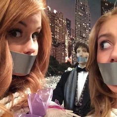 two women with duct tape around their mouths