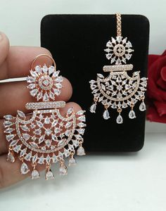 American DIAMOND Rose Gold/ Silver Plated EARRING MANGTIKA set, Indian bridal, Cz Stones Chandbali Earring tika Sabyasachi Designer Jeweller For Women & Girls By Electrifying Jewellery STYLE TIP - These earrings are a perfect accessory to match your daily wear needs. A perfect go to pair for a luncheon with girls, a classic work day or date night. These Combos are based in Rose Gold copper alloy with rhodium plating. Care Tip - 1. Keep away from moisture and perfume 2. Store in cotton or zip loc Rose Gold Chandbali Jewelry For Wedding, Rose Gold Chandbali Wedding Jewelry, Wedding Jhumkas With Intricate Cubic Zirconia Design, Wedding Cubic Zirconia Jhumkas With Intricate Design, Wedding Danglers With Intricate Design In Cubic Zirconia, Wedding Chandbali Jhumkas With Cubic Zirconia, Cubic Zirconia Chandbali Jhumkas For Wedding, American Diamond Chandbali Bridal Earrings, Chandbali American Diamond Bridal Earrings For Wedding