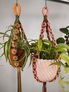 three hanging planters with plants in them