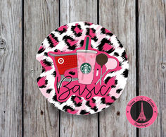 a pink and black leopard print plate with a starbucks cup on it