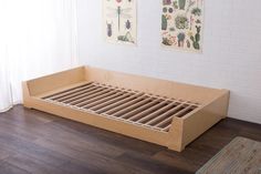 the bed frame is made out of plywood and has slats on each side