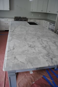 a large kitchen island with marble counter tops