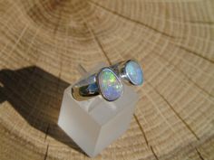 Open ended silver ring with 2 Coober Pedy opals. Both opals have beautiful bright yellow, green, blue and purples. One is approximately 0.8ct and 8x6mm, the other 1ct and 9x6mm. Size S UK/Aus, 9.25US, plain band, 4.5mm width. As ring is open ended there is some variation on size available. Silver Opal Ring, Christmas Gifts For Girlfriend, Coober Pedy, Plain Bands, Open Ended, Pendant Rings, Opal Ring, Australian Opal, Opal Rings