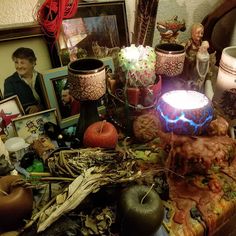 a table topped with pictures and candles on top of it