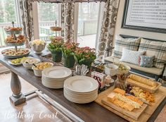 a table filled with plates and trays of food