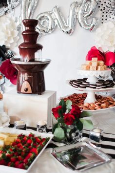 a table topped with lots of different types of food and desserts next to each other