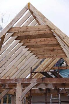 the roof is made out of wood and has a wooden rafter on it's side