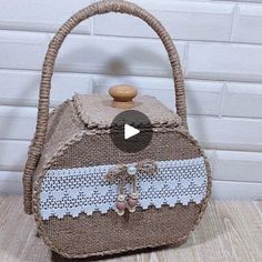 a handbag made out of burlock and lace with a wooden handle sitting on top of a table