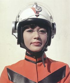 a woman in an orange uniform wearing a helmet