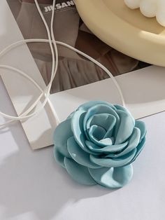 a blue flower sitting on top of a white table