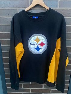 "Vintage 1990s Pittsburgh Steelers Crewneck  Sweatshirt - Size L (Length 28.5\" Chest 23\") - Overall used vintage condition (stains pictured) - Message for more information Please take note of the measurements listed as these are vintage clothes and may fit different than the tag size. Follow our page for more vintage clothing drops!" 90s Long Sleeve Tops With Embroidered Logo, 90s Crew Neck Top With Embroidered Logo, 90s Style Crew Neck Sweatshirt With Embroidered Graphics, Black Throwback Crew Neck Sweatshirt, 90s Style Winter Sweatshirt With Embroidered Graphics, Retro Black Crew Neck Sweatshirt, Black Retro Crew Neck Sweatshirt, Retro Crew Neck Sweatshirt With Embroidered Graphics, Black Long Sleeve Throwback Tops