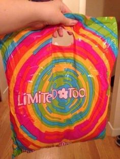 someone holding onto a bag with the word'little bittoo'on it