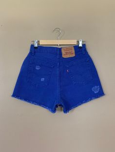 "High waisted 90's denim shorts. Made by Levi's in rare bright blue denim wash. Shorts are in excellent clean condition. Brand new with tags before I made them into cutoff shorts. These have been cutoff, distressed by hand, and washed once. Measurements are taken zipped or buttoned up and laid comfortably flat then x 2 for total circumference (inches) Tag Size 7 Levi's 560 100% Cotton Made in USA Waist 28\" Hips 42\" Length 13.5\" Inseam 2.5\" Rise 12\" leg opening circumference 26\" All items a 90s Style Shorts With Belt Loops, 90s Inspired High Rise Blue Bottoms, Blue Cutoff Jeans With Belt Loops, 90s Inspired Mid-rise Blue Bottoms, Vintage Jean Shorts With Belt Loops For Summer, 90s Inspired Denim Jean Shorts For Summer, Blue Cutoff Jean Shorts With Pockets, Blue Fitted Cutoff Jean Shorts, Retro Cutoff Bottoms For Summer