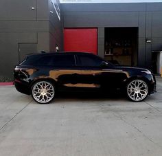 a black car parked in front of a building