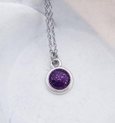 "Cremation Necklace - Pet Loss Gift - Ashes Jewelry - Memorial Jewelry - Pet Cremation Jewelry - Memorial Keepsake - Glitter Ashes - Dainty This beautiful, dainty necklace is made using your beloved pet's actual ashes. You may be able to see the ashes, but I will add a touch of glitter to highlight the piece. The disc pendant is approximately 1/2\" and graces a dainty stainless steel link chain. Please contact us after you've ordered for instructions on how/where to ship the ashes for your neckl Sparkling Purple Jewelry For Gift, Sparkling Purple Jewelry Gift, Purple Glitter Jewelry Gift, Purple Glitter Jewelry For Gifts, Silver Glitter Necklace For Gift, Glitter Round Jewelry As Gift, Round Glitter Jewelry As Gift, Round Glitter Jewelry For Gifts, Pet Cremation Jewelry