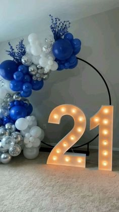 balloons and lights are arranged in the shape of numbers for a 21st birthday party or celebration