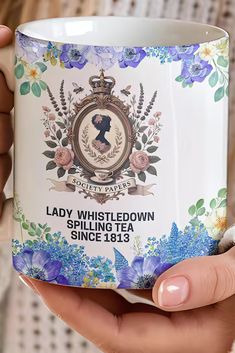 Step into the enchanting world of the Regency Era with this Bridgerton Mug, inspired by the iconic Lady Whistledown. Perfectly adorned with elegant blue wildflower florals, this mug is a timeless treasure for any Bridgerton fan or vintage book lover. Whether you're enjoying a morning tea or an evening coffee, this Regency-style tea cup will add a touch of sophistication to your day. An ideal gift for her, this Bridgerton-inspired mug makes the perfect present for birthdays, holidays, or just because. Its charming design is both functional and decorative, making it a standout addition to any collection. Surprise your loved ones with a touch of vintage elegance that celebrates their love for period dramas, classic literature, and all things Bridgerton!