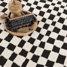 a black and white checkered rug with a sign that says, i have like a beautiful life