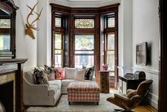 a living room filled with furniture and windows