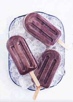 three popsicles sitting on top of ice