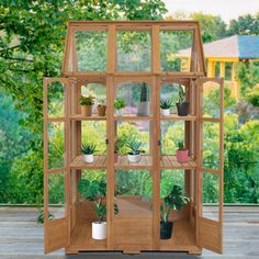 a wooden shelf with plants inside of it