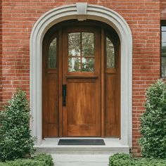 the front door is made of wood and has two sidelights on either side of it