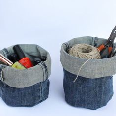 two denim cup holders with scissors and yarn in them