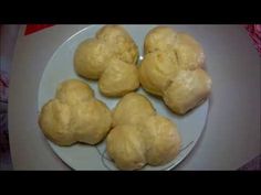 four pieces of bread on a plate ready to be baked and eaten by someone else