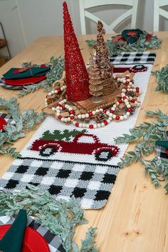 the table is set with christmas decorations and plates