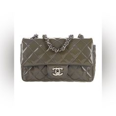 Chanel Shoulder Bag From The 2012 Collection By Karl Lagerfeld Patent Leather | Silver-Tone Hardware| Chain-Link Shoulder Straps | Single Exterior Pocket | Leather Lining & Dual Interior Pockets | Turn-Lock Closure At Front Shoulder Strap Drop: 21.5" Height: 5" Width: 8" Depth: 2.5" Comes With Box, Authentication Card & Dust Bag. Sold As-Is. Pre-Loved Condition. Please Note There Is Heavy Discoloration Throughout The Bag. You Can Look Into Possibly Having The Bag Dyed To A Darker Color. Chanel Mini Flap Bag Silver, Chanel Shoulder Bag, Leather Silver, Flap Bag, Dark Colors, Karl Lagerfeld, Chain Link, Shoulder Straps, Patent Leather