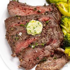 a white plate topped with steak and broccoli