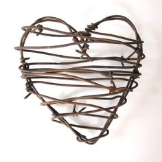 a heart made out of barbed wire on a white background