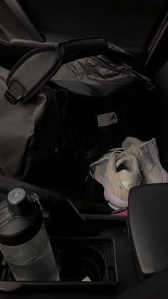 the back seat of a car with items in it and a water bottle next to it