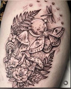 a black and white photo of a tattoo on the thigh