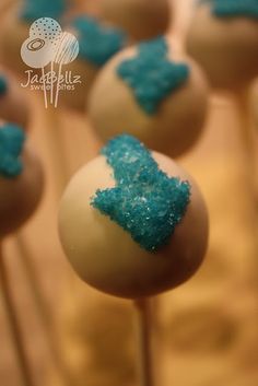 cake pops with blue and white frosting on them