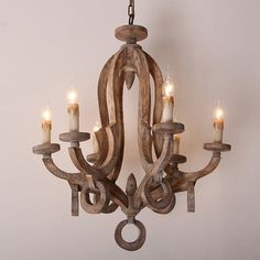 a wooden chandelier with candles hanging from it