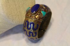 This is a beautiful antique moroccan bracelet. it is lapis brass turquoise. it is inside measure width 2 5/16 x aprox 2 inches. it weighs 106.3 grams. Bohemian Blue Brass Bracelets, Moroccan Bracelet, Antique Bracelets, Cuff Bracelets, Jewelry Bracelets, Brass, Turquoise