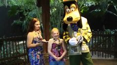 two women and a boy standing next to a dog mascot