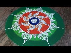 a green and red plate sitting on top of a wooden table next to a brown floor