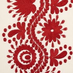 a red and white floral design is shown on the side of a piece of cloth