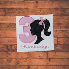 a sticker with the number 3 on it and a silhouette of a woman's head