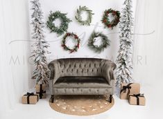 a living room decorated for christmas with wreaths on the wall