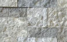 a stone wall that is made out of different types of stones and has been used as a background