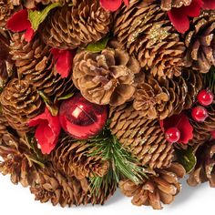 a bunch of pine cones with christmas decorations