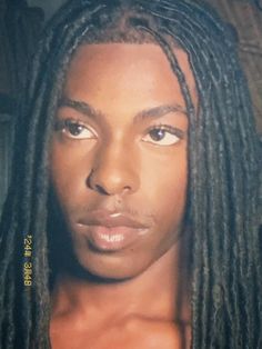 a man with dreadlocks looking at the camera